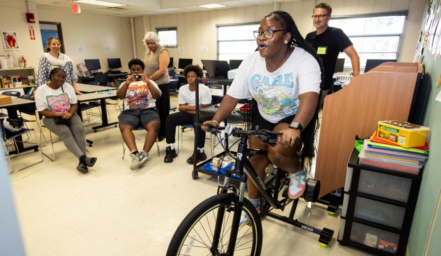 High school students from Buffalo schools participate in the STEMcyclists Summer Camp organized by Noemi Waight, with the Graduate School of Education. Students in the program participated in cycling-related activities intended to facilitate a better understanding of how bikes work and what happens in our bodies while riding a bike. The group was photographed in the Hayes Hall Annex and in the space outside in July 2025.